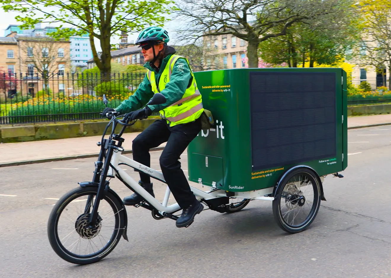 An Urb-it courier on a solar powered tricycle